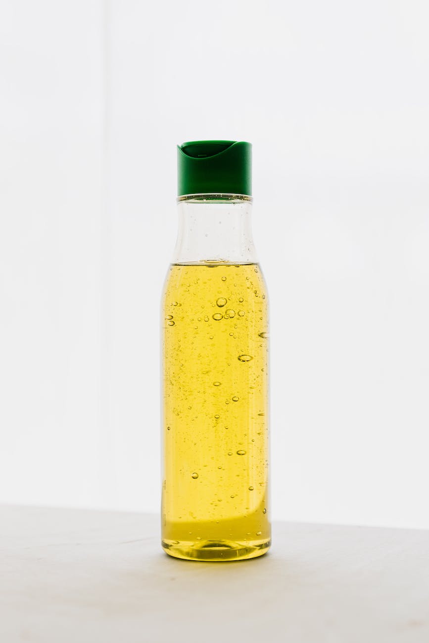 plastic bottle of yellow body oil